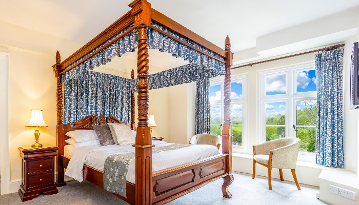 4 poster bed with views out of the large windows