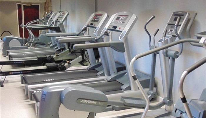 Lancashire Manor Hotel - Gym - a row of treadmills with a rowing machine in the back from inside the gym